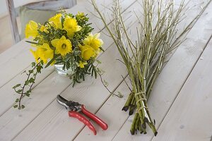 Yellow daffodil bouquet in wreath of dogwood branches