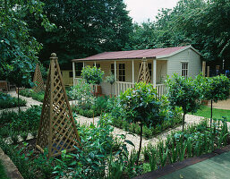FAMILY POTAGER by Clare MATTHEWS: GRAVEL, WOODEN OBELISKS, CLIPPED Box AND Bay AND A SUMMERHOUSE