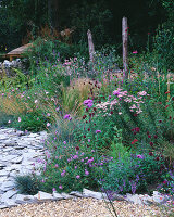 Der ummauerte Garten mit Holzbank, Stipa tenuissima, Schiefer, Monarda 'Beauty of Cobham', Scabiosa columbaria 'Nana', Achillea 'Love Parade'