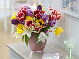 Tying a colourful tulip bouquet 