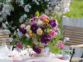 Romantic arrangement made of roses and clematis (clematis)