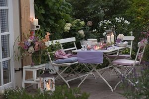 Evening terrace table decoration with lanterns, dahlia and hydrangea