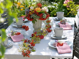 Table decoration with garland of sorbus (rowanberry) and fennel