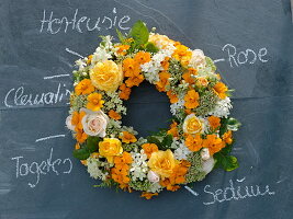 White and yellow late summer bouquet of marigolds and clematis