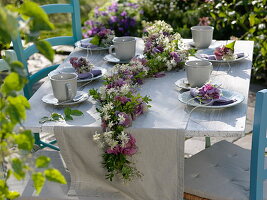 Late summer table decoration with flower garland