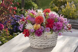 Autumn bouquet in a white basket with handles