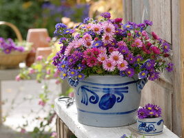 Autumn bouquet of aster in lard pot with salt glaze