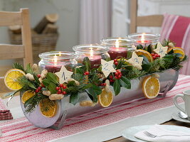 Unusual Advent wreath with preserving jars in a tin gutter