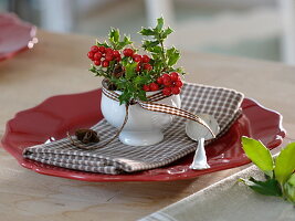 Small bowl with holly as napkin decoration