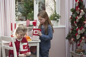 Mädchen packen Nikolaus-Geschenke aus