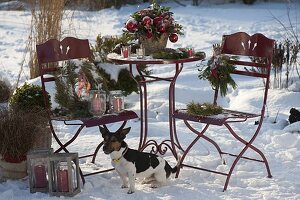 Snowy terrace decorated for Christmas with bouquet of holly