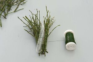 Ranunculus in dress made from blueberry branches (2/3)