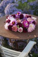 Arranged wreath of dahlia (dahlias) on rust table