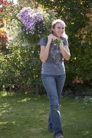 Woman with freshly cut Aster (autumn asters)