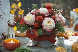 Autumn bouquet with pink (roses and rose hips), physalis (lanterns)