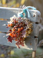 Frozen autumn bouquet with Malus (ornamental apples), pink (rose hips)