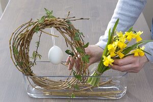 Easter window decoration with willow egg and daffodils