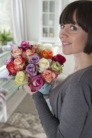 Woman enjoying a beautiful bouquet of pinks (roses)