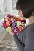 Woman rejoices over a beautiful bouquet of pinks (roses)