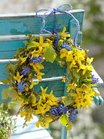 Blue-yellow spring wreath on the back of a chair