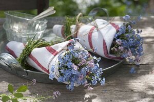 Miniature bouquet of myosotis (forget-me-not) in a florist's tube