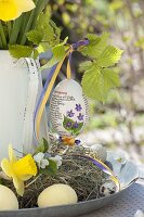 Hand-painted Easter egg: violet, on a branch of Corylus