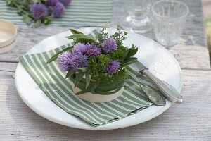 Herb bouquet in cheese box as napkin decoration