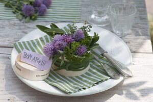 Bouquet of herbs in cheese box as napkin decoration