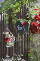 Welcome greeting at the fence: heart of slate with grasses and flowers