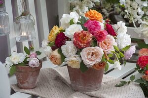 Bouquets of freshly cut pinks (roses) placed in clay pots