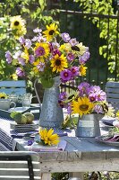 Table decoration with sunflowers, decorative baskets and apples