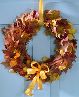 Door wreath made of various autumn leaves, oak and maple leaves