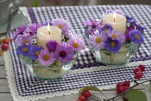 Kleine Windlichter mit Blüten von Aster (Herbstastern)