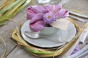 Autumn table decoration with grasses, heather and chrysanthemum flowers