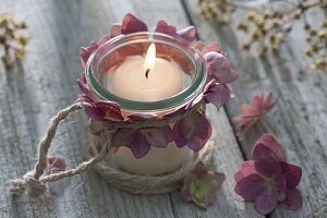 Small lantern with flowers of hydrangea (hydrangea) and burlap string