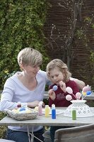 Children making and painting Easter eggs