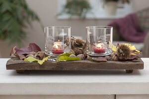 Elongated wooden bowl with lanterns, glasses with etched motifs