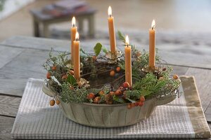 Autumn wreath with yellow candles in granny's baking tin