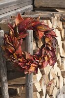 Wreath made of leaves of Prunus (ornamental cherry) at the firewood storehouse