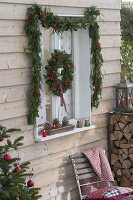 Decorate window with garland and wreath for Christmas