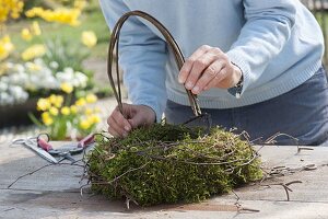 Easter nest with wooden rabbit made of moss wreath and birch branches