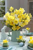 Easter table decoration with narcissus and easter bunny