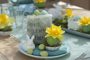 Easter table decoration with narcissus and easter bunny