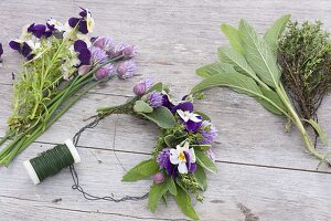 Kleinen Kranz aus Kräutern und essbaren Blüten binden