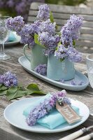 Lilac table decoration with light blue dishes