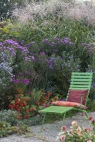 Liege on the autumnal bed with perennials and grasses