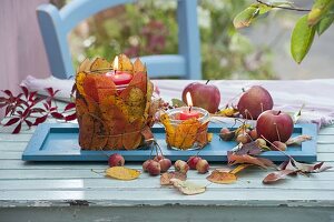 Autumn table decoration with leaves-lanterns and apples