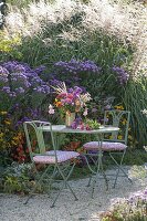 Colorful cottage's garden bouquet on the table at the aster bed