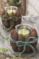 Lanterns with green candles, covered with Picea cones