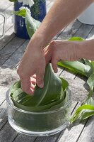 Table arrangement of corn leaves in glass bowl